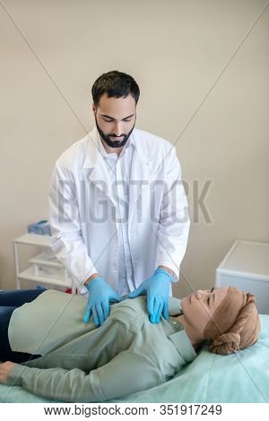 Dark-haired Mammologist Palping Breasts Of His Patient