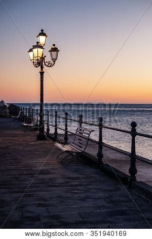 Pier in Amalfi town at sunset, Italy