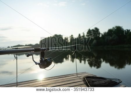 Carp Fishing On Beautiful Blue Lake With Carp Rods And Rod Pods In The Summer Morning. Fishing From 