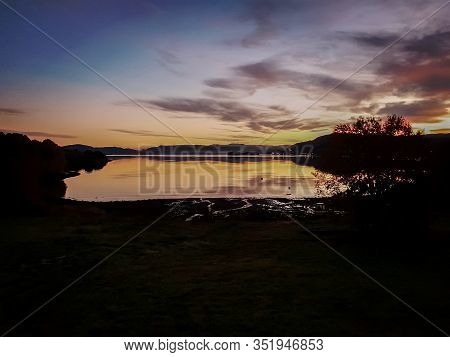 Sunset With Siluets Over The Ocean In Norway