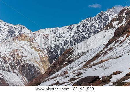 Natural Monument El Morado, Central Andes Of Chile. A Snowy Rocky Mountain
