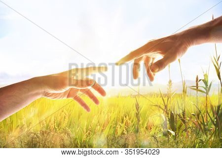Hands With Palms Up In Field With Sparkles And Ray Of Light. Representation Of The Christian Concept