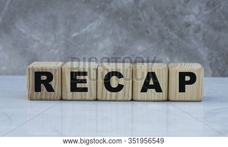 Concept Word Recap On Wooden Cubes On A Gray Background