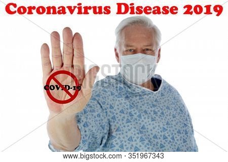 Coronavirus. Convid-19. A medical patient wears a face mask and holds out his hand in a NO CORONAVIRUS image. Isolated on white. Room for text. Clipping Path. CONVID-19 is spreading world wide. 