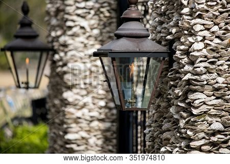 Architectural detail of gas lamps on oyster shell wall in South Carolina.