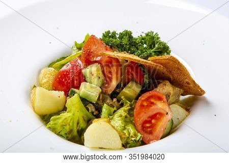 Salad With Black Sea Rapan Meat, Dressed With Honey Sauce. With Rye Crackers. On A Gray Canvas Cloth