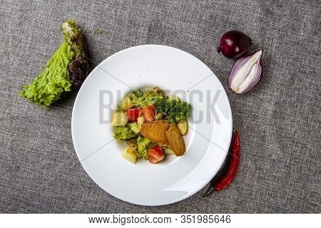 Salad With Black Sea Rapan Meat, Dressed With Honey Sauce. With Rye Crackers. On A Gray Canvas Cloth