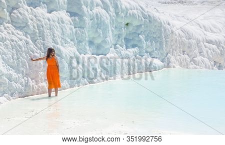 Lady In Orange Dress Posing For Photo At Pamukalle N Turkey