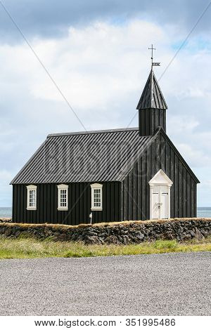 The Black Tarred Búðakirkja Timber Church On The Seashore In Iceland