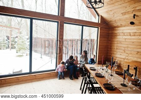 Mother And Kids In Modern Wooden House With Table, Spending Time Together In Warm And Love.