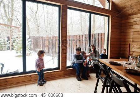 Mother And Kids In Modern Wooden House With Table, Spending Time Together In Warm And Love.