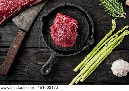 Raw Beef Fillet Steaks With Spices Set, On Frying Cast Iron Pan, On Black Wooden Table Background, T