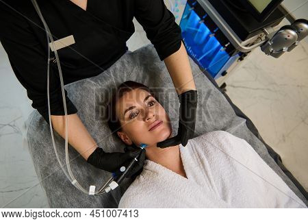 Beautiful Caucasian Woman Lying On A Massage Table And Getting A Hydro Microdermabrasion Facial Trea