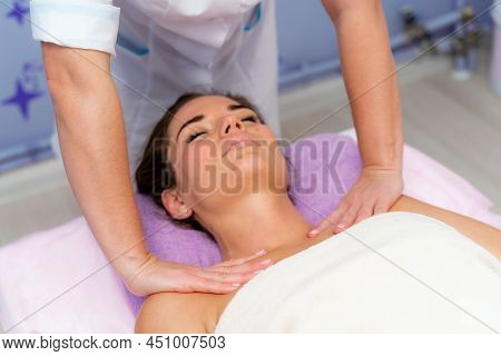 Facial Massage. A Woman Is Given A Massage In A Beauty Salon. Close-up.