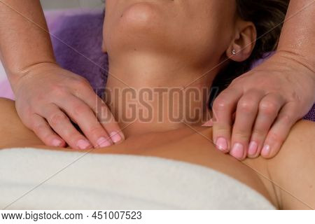 Facial Massage. A Woman Is Given A Massage In A Beauty Salon. Close-up.