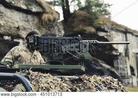 Fireaim Using A Heavy Machinery Rifle Mounted Weapon For Military Purpose. High Quality Photo