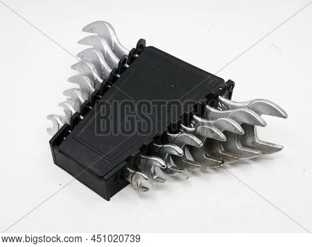 An Old Tool Set Of Stainless Steel Spanners In A Black Box Isolated In A White Background