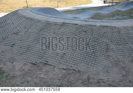 Edge Of Off-road Asphalt Track With Jumps And Undulating Surface And Jumps On Bumps. Track For Scoot