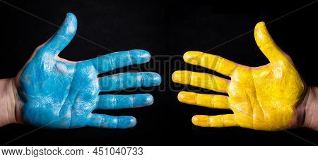 Ukraine Flag Color. Stop The War Background. Connected Hands. Paint On Open Hand Symbolic Gesture Of