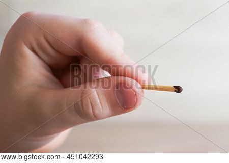 The Child Holds A Lit Match And It Burns With A Flame