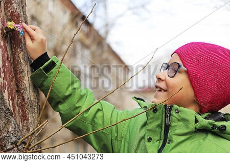 Girl And Child Playing With A Toy On The Street