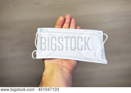 A Helping Hand Always Holds Out A Medical Mask To Patient