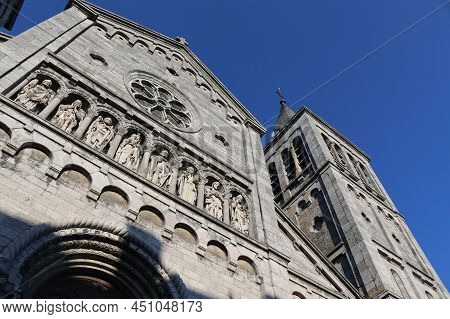 Exterior View Of Our Lady Of The Visitation Church In Rochefort,  With Blue Sky. The 19th Century Ch