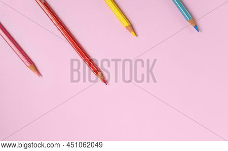 Color Pencils On A Light Pink Background. Top View With Space For Text. Back To School Concept. Flat