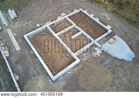 Top Down Aerial View Of Building Works Of New House Concrete Foundation On Construction Site.