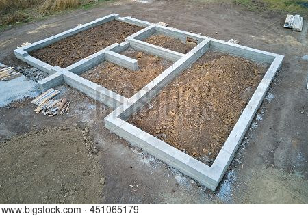 Top Down Aerial View Of Building Works Of New House Concrete Foundation On Construction Site.