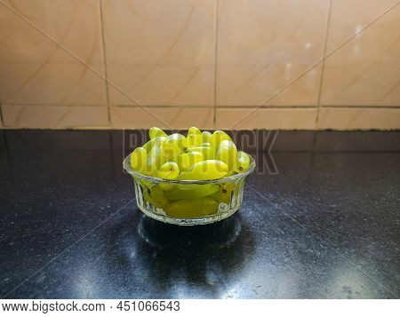 Stock Photo Of Glass Bowl With Fresh, Sweet, Ripe , Organic Green Grapes, Kept On Black Granite Kitc