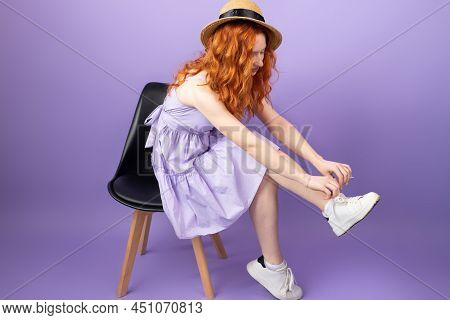 Full Length Body Young Redhead Woman In Straw Hat And Sundress Sitting On The Chair And Tying Shoela