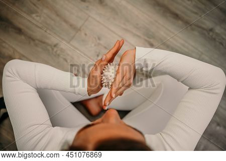 Athletic Slim Caucasian Woman Doing Thigh Self-massage With A Massage Ball Indoors. Self-isolating M