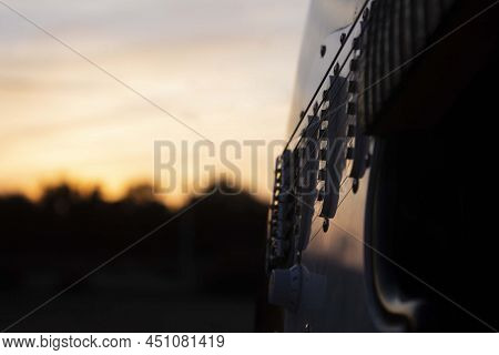 Closeup Of An Electric Guitar With The Sunset. Guitar And The Sunset. Guitar. Electric Guitar. Music