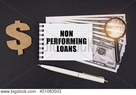 Business And Finance Concept. On A Black Surface Lie Dollars, A Symbol, A Magnifying Glass, A Pen An