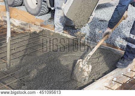 Pouring Cement Or Concrete With A Concrete Mixer Truck, Construction Site With A Reinforced Grillage