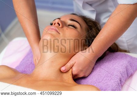 Facial Massage. A Woman Is Given A Massage In A Beauty Salon. Close-up.
