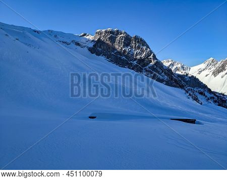 Snowy Alp Hut On A Ski Tour In The Swiss Mountains. Ski Mountaineering In Winter. Ski Touring