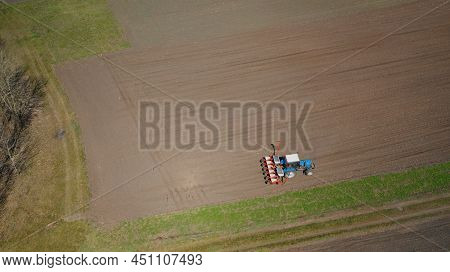 Farming: A Farmer On A Tractor Works The Field Before Sowing