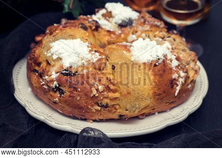 Portuguese Christmas Cake Bolo De Rainha On White Dish On Black Ceramic