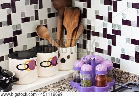 Kitchen Utensils, Wooden Spoons, Spice Jars, Organization And Storage Containers On Kitchen Countert