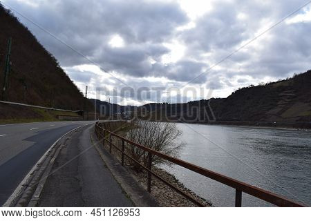 Damaged Road Through Mittelrheintal On A Gloomy Day With The Dark Clouds Above