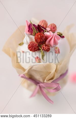 Easter Cake On A Pink Background Decorated With Dried Flowers