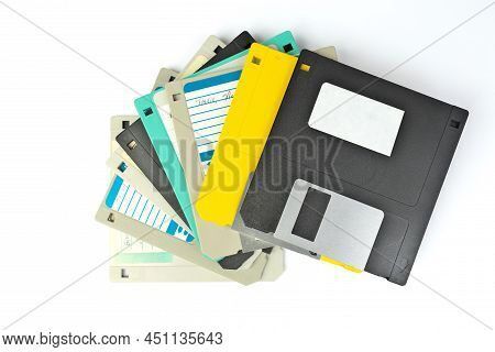 A Pile Of 3.5 Inch Floppy Disks For Background. Retro Digital Storage Technology.