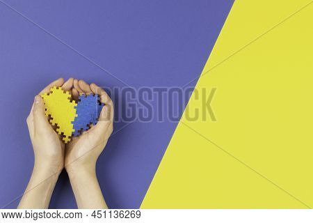 World Down Syndrome Day Background. Child Hands Holding Blue And Yellow Down Syndrome Awareness Day 