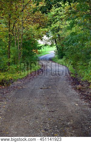 Narrow Dirt Lane Twists And Turns Between Trees On A Country Road In Tennessee.