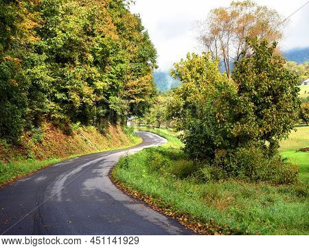 Curving Country Road Winds Around The Appalachian Mountains In Tennessee.  Road Disapears Around The