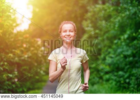 Young Fitness Woman Running At Forest Trail.