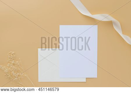 Blank Greeting Card Invitation Mockup 5x7 On Envelope With Dry Flowers And Ribbon On Paper Backgroun