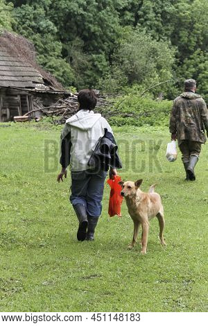 Dog On The Farm Meets Owners Who Come The Way Of The Forest